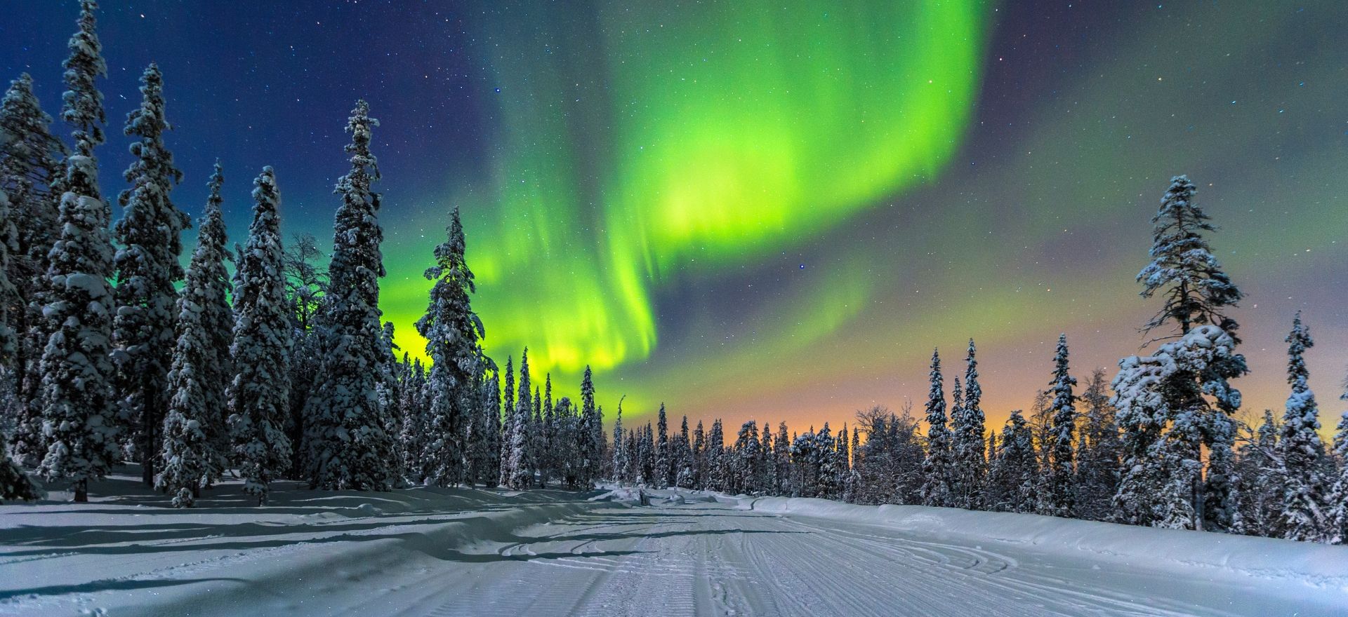 A magical scene of Lapland, Finland with the Northern Lights (Aurora Borealis), ideal for a luxury Christmas getaway by private jet charter.